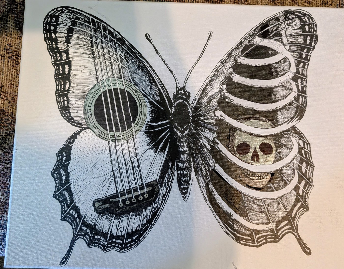 Both Wings — a butterfly with a guitar for one wing and a ribcage with a skull for the other
